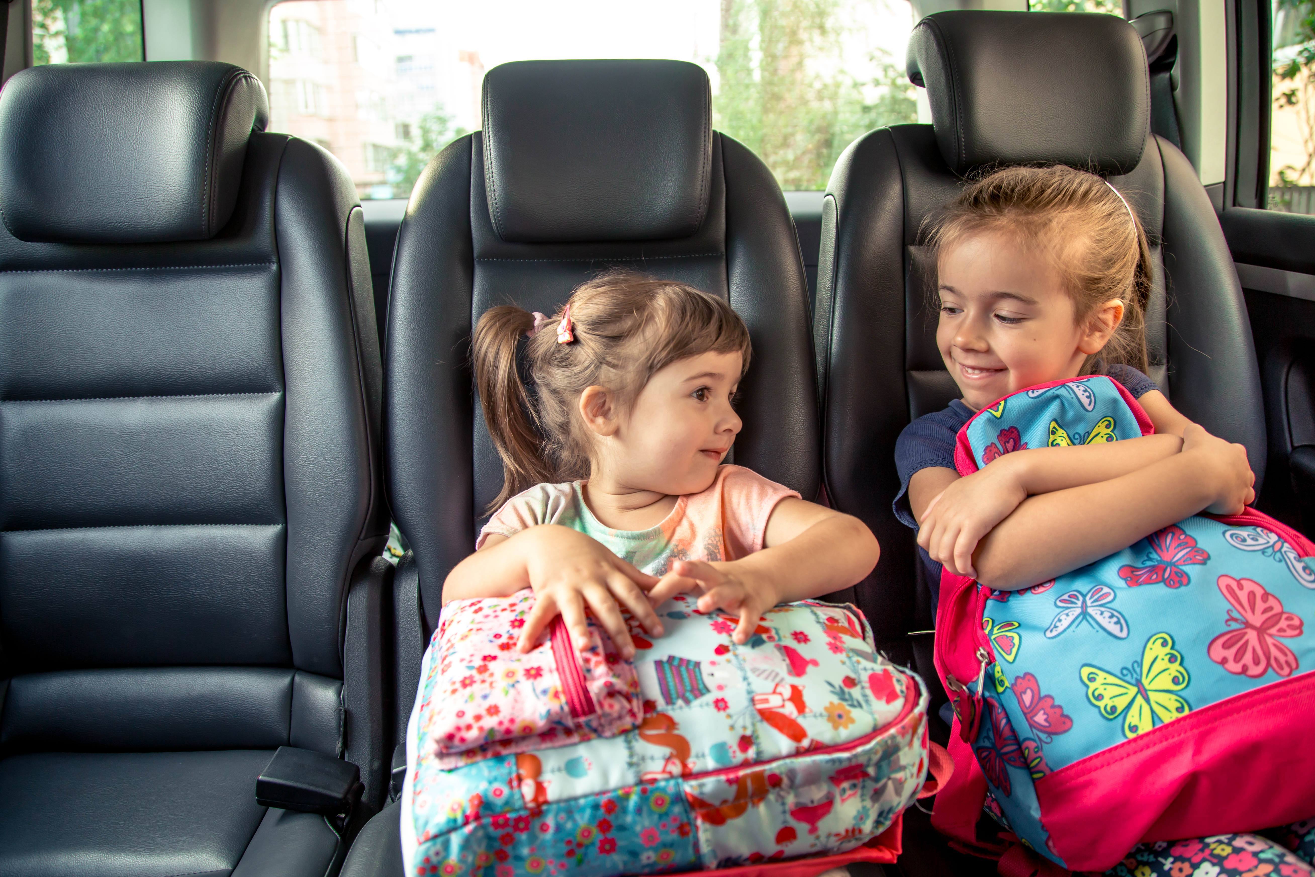 03 children-car-go-school-happy-sweet-faces-sisters